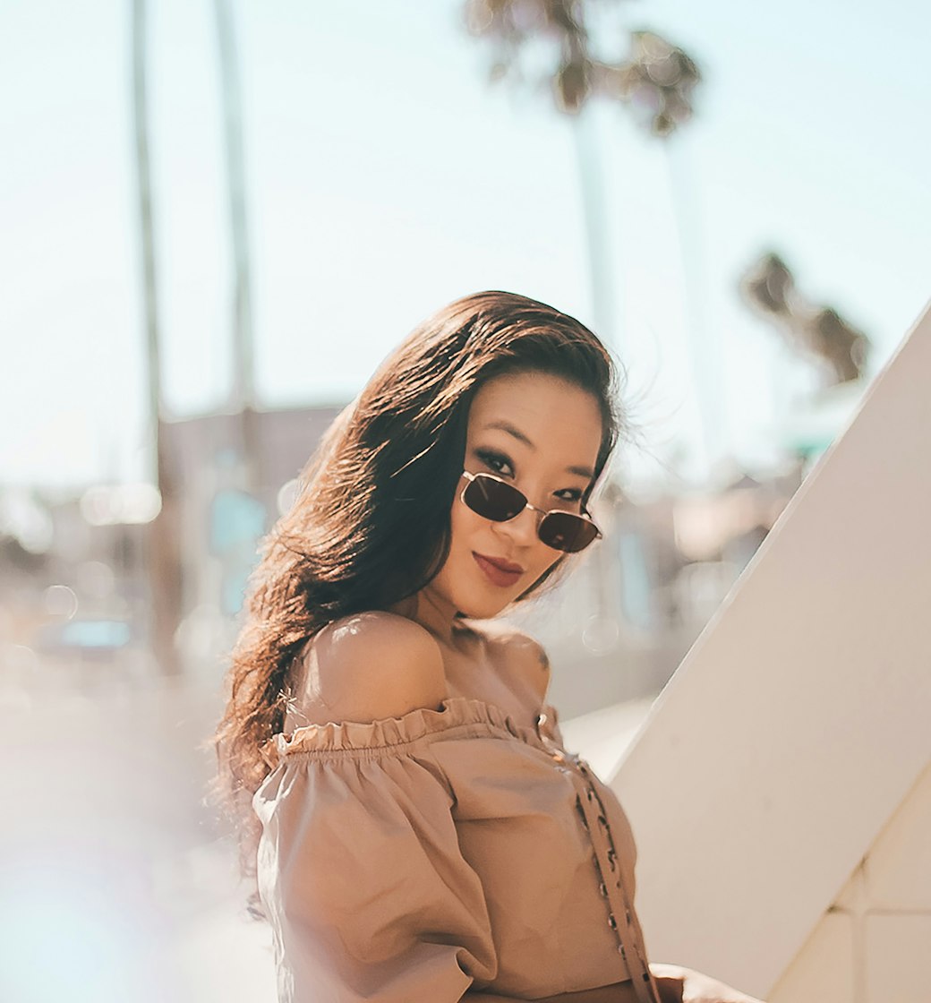 Confident woman in coastal sunlight